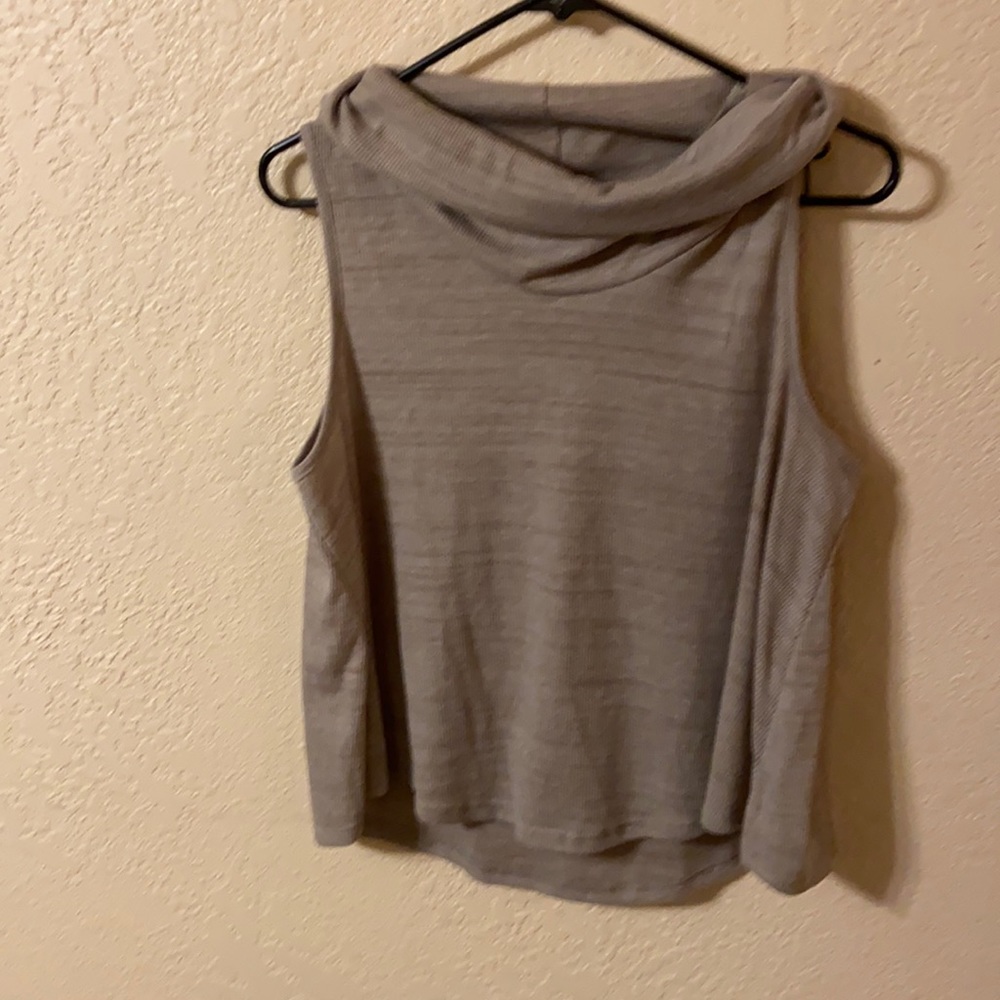 Woman’s turtle neck sleeve less shirt